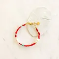 Detailed macro view of Bohemian beaded bracelet with red coral and turquoise stone accents - Red, White and Blue Ethnic Style (Bracelet 120)