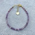 Bohemian purple amethyst beaded bracelet with gold heart charm on denim background - Purple Crystal Faceted Style (Bracelet 19)
