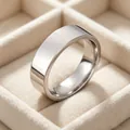 Minimalist 6mm silver stainless steel band ring for men displayed in a soft velvet box - Steel