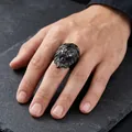 Detailed close-up of a bold black punk lion head ring for men worn on a male hand - US 7 / Black