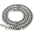 Macro view of a silver stainless steel Cuban link chain with 6-side grinding detail. - Bracelet / 10mm Wide (18cm) / Silver