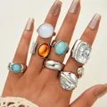 Irregular silver lava ring set with turquoise and cat-eye stones worn on female hand - Eight-Piece Lava Texture Irregular Rhinestone Ring Set (6513602HB)