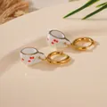 Detail view of unique miniature white ceramic teacup earrings with red cherry pattern. - Cherry Teacup