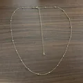 Detail view of a dainty 18K gold plated stainless steel bead waist chain on wood. - Tail Chain with Rhinestone / 66+15cm / Gold