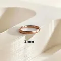 Close-up of 2mm minimalist rose gold ring with elegant brushed texture on white stand - US 4 / 2mm Brushed Rose Gold