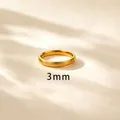Detail macro shot of a 3mm brushed 18k gold titanium steel plain band ring for women - US 4 / 3mm Brushed Gold