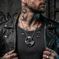 Detail view of a vintage dumbbell plate pendant necklace on a tattooed male model. - Pendant with Box Chain / Vintage Silver With Steel Chain