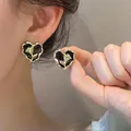 Vintage gold-toned rose heart stud earrings with black enamel detail for women. - Black & Gold