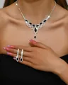 Elegant silver-tone necklace and drop earrings set with black crystals on a model - 1341 Black