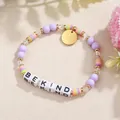 Makrodetail eines handgefertigten Perlenarmbands mit 'BE KIND'-Buchstabenperlen und Akzenten - BE KIND Stil (ZJ15927)