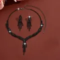 Elegant black crystal teardrop necklace and earring set displayed on a dark red background - 733 Black