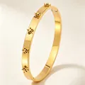 Close-up detail of a luxury gold titanium steel bangle with unique decorative star accents - Gold Five-pointed Star