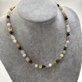 Detail shot of the irregular colorful natural stone necklace on a gray velvet bust - One Size / Purple Yellow Color Necklace