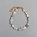 Close-up of vintage irregular natural stone beads and gold heart tag on bracelet - One Size / Fresh Pink Green Bracelet