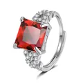 Close-up of a luxurious silver-toned adjustable ring with a large square red gemstone - Adjustable Open / Ruby
