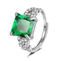 Detailed view of luxury square green gemstone and sparkling accent stones on silver ring - Adjustable Open / Emerald