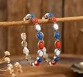 Bohemian hoop earrings with red white and blue stones in a rustic wooden setting. - Tri-Color Hoop Earrings (5733)