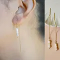 Elegant gold chain long earrings with freshwater pearls shown as worn and laid flat - Long Freshwater Pearl Ear Threaders