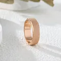 Detailed macro view of a rose gold matte frosted band ring with a textured finish. - US 5 / Rose Gold Large