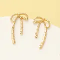 Stylish golden bow-shaped stud earrings featuring a unique textured metallic finish - Textured Bowknot Stud Earring (N-041)