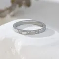 Macro shot of silver ring featuring three inlaid sparkling crystals on white rock - US 5 / Silver