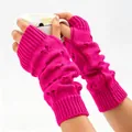 Detail of bright pink knitted arm warmers featuring heart patterns and soft wool texture - Rose Red