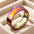 Detailed close-up view of a 6mm rainbow iridescent stainless steel ring in a beige box - Size 5 / Rainbow