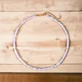 Macro detail of iridescent semi-precious stone beaded necklace with gold-tone metal spacers. - Pale Pink Spacers