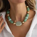 Elegant fashion green resin and gold bead necklace worn by a model in a white shirt - Gold (07833)