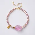 Elegant purple freshwater pearl bracelet with pink carved centerpiece and gold coin charm - 4-5mm Purple Freshwater Pearl - Fluorite Pixiu Bracelet