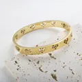 Βραχιόλι από ανοξείδωτο ατσάλι 18K 8mm με κούφια σύμβολα ζωδίων σε σχήμα καρδιάς - Χρυσό Χειροπέδα (Χρυσό)