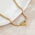 Close-up of a gold heart-shaped tennis bracelet with sparkling micro-pave stones. - Gold