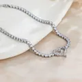 Detailed close-up of a sparkling heart-shaped tennis bracelet on a white textured display - Silver