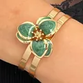 Elegant gold-tone bracelet with green drip oil marbled flower design. - Bangle (11895) / Green