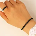 Handmade geometric beaded jewelry set featuring black and gold tiny beads on hand - Bracelet & Ring Set Black 12401