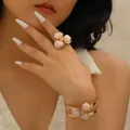 Elegant gold-tone flower ring and open cuff bracelet jewelry set for modern women - Bangle & Ring Set (4613+7044)