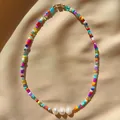 Close-up of bohemian colorful seed bead necklace with three pearls on silk fabric background. - Short Choker Length / Rainbow with 3 Pearls