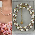 Detail of bohemian freshwater pearl necklace with gold heart charm in a jewelry box. - Short Choker Length / Red Yellow Gradient