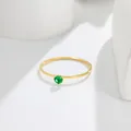 Close-up of a minimalist 14K gold thin ring featuring a brilliant round green gemstone. - US 5 / Gold (Green Rhinestone)