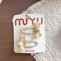 Handgemachtes Set süßer milchgelber Haarklammern mit Tupfen-Schleife für Mädchen - 3-Snap-Clips mit gepunkteter Schleife