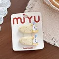 Süße handgefertigte cremegelbe gepunktete Haarspangen mit weißem Enten-Stickdesign - 6-Snap-Clips mit gepunkteter gelber Ente
