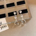 Detailed view of elegant silver drop earrings with faceted clear teardrop crystals. - Crystal Silver-Plated Long Earrings