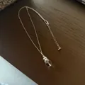 Elegant silver chain necklace with a transparent crystal ball pendant on wood background - Crystal Gourd Necklaces