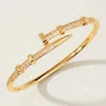 Elegant golden nail bangle featuring premium zircon stones and a modern open design. - Gold Nail Open Bangles BS-J5507G