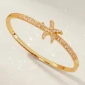 Luxurious gold plated bangle bracelet featuring a sparkling zircon starfish design - Gold Trendy Zirconia Bangles BS-J5658G