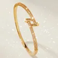 Luxury gold-plated nail bangle encrusted with shimmering cubic zirconia stones. - Gold Elegant Modern Bangles BS-J5670G