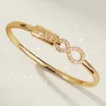 Luxurious gold-plated bangle featuring a pavé infinity symbol and LOVE plate detail - Luxury Party Gold Bangle BS-J5532G