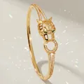 Luxurious gold-tone panther head bangle with sparkling zircon inlay for stylish women. - Gold Evening Gown Bangle BS-J5602G
