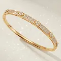 Luxurious gold plated bangle featuring zircon paved bands and flower clusters for women - Gold Evening Party Bangle BS-J5627G