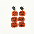 Halloween acrylic tiered pumpkin earrings with glitter black studs on white background - Three Pumpkin Faces Style (N101)